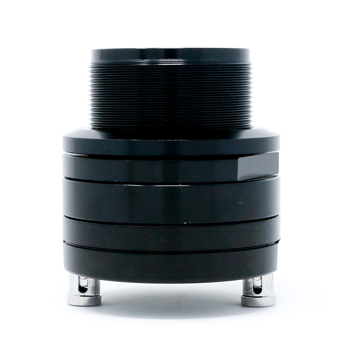 The Pro Series 1" PRO Audio High-Frequency Component Horn Tweeter - P1T is a black, cylindrical design with metallic feet, textured ridges on top, and two silver pins underneath. Its smooth, shiny body enhances its reflective surface, perfect for professional audio high-frequency applications.