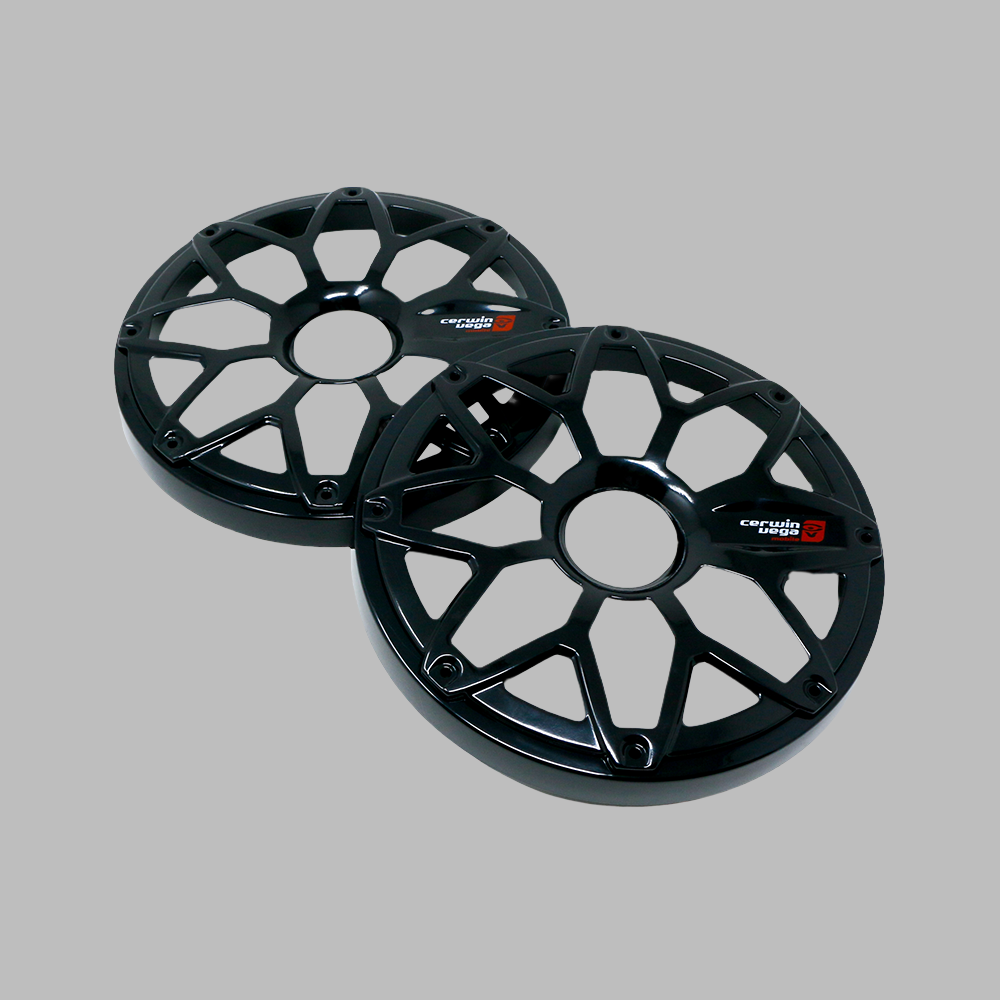 Two black car wheel center caps with a multi-spoke design sit against a gray background, featuring a "Corvette C8.R" logo. Resembling the RPM Stroker 6.5” Flush Mount Speaker Grill's sleekness, the glossy caps subtly reflect light and are positioned diagonally, one slightly overlapping the other.