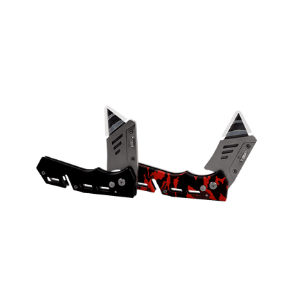 The Cerwin Vega Pocket Knife features futuristic angular blades and a sleek design. The left is primarily black, while the right boasts a striking red and black pattern. Both have metallic accents with geometric shapes and premium stainless steel blades positioned apart, facing upward.