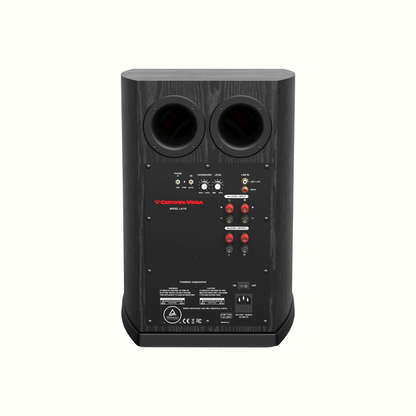 The back of the black 10” HOME THEATRE POWERED SUBWOOFER SPEAKER-LA110 showcases two circular bass ports, red and white RCA inputs, speaker wire terminals, a power switch, voltage selector, and branding in red text on a wood grain surface. Labels and safety icons are also visible.