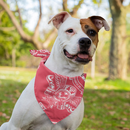 A white dog with brown spots on its ear sports the Cerwin-Vega! Signature Red Bandana, which features a white eagle design. The happy pup, tongue out, relishes the grassy park against a backdrop of blurred trees and greenery, delighting audio enthusiasts.