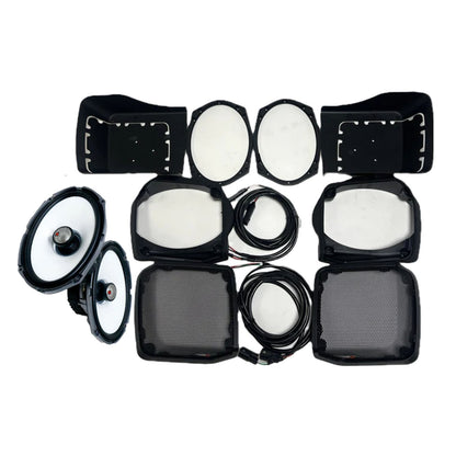 On a white background, components from the 1998-2013 Harley Davidson® Cut-in Lid Kit with SM69F4 (4Ω) by Cerwin Vega, including speaker cones, black rectangular grills, wiring, and casing parts, are symmetrically arranged to resemble a complete Harley Davidson speaker kit.