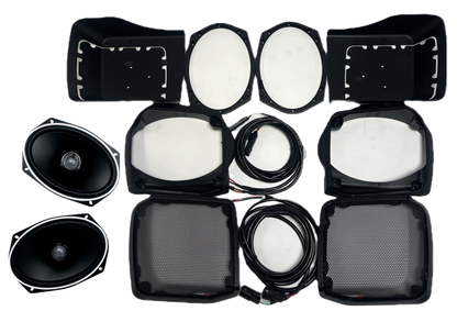 A Harley Davidson Lid Kit layout on a white background features two oval speakers, two round subwoofers, two rectangular speaker covers with mesh grilles, multiple black cables, and six black plastic mounting frames.