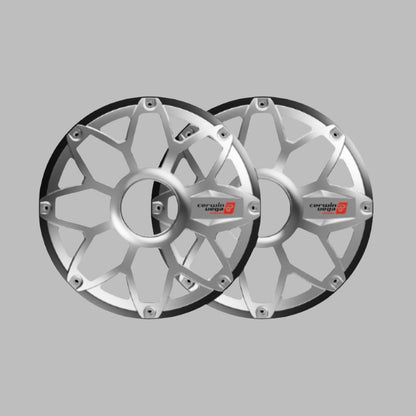 The RPM Stroker 10" Flush Mount Speaker Grill pair is shown against a gray background, each with a silver star-like pattern and angular edges. They feature a central hub with "certain logo" in black and a red emblem, resembling modern car wheel covers.