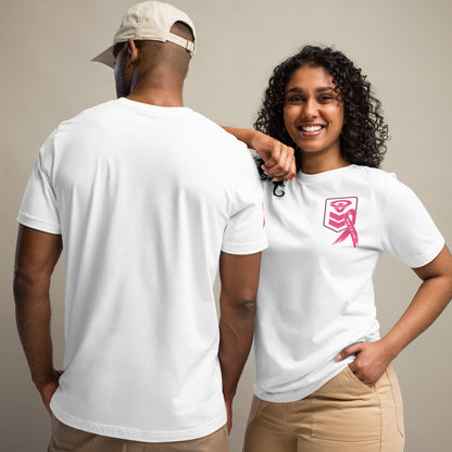 A smiling woman with curly hair wears a Cerwin-Vega Breast Cancer Awareness T-shirt featuring a pink ribbon. Beside her, a man showcases the back of the same white T-shirt and wears a beige cap. Both are dressed in beige pants against a neutral background.