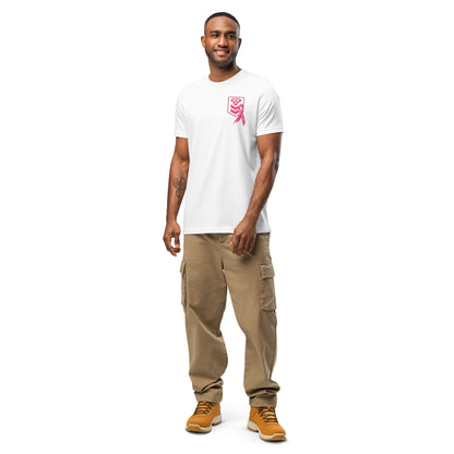 A smiling man stands on a white background, confidently posing in beige cargo pants and brown boots. He wears the Cerwin-Vega Breast Cancer Awareness T-Shirt featuring a pink ribbon graphic. With short hair and a beard, one leg slightly bent, his hands rest relaxed at his sides.